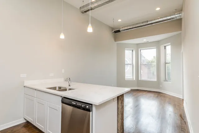 a view of a room with wooden floor and white walls