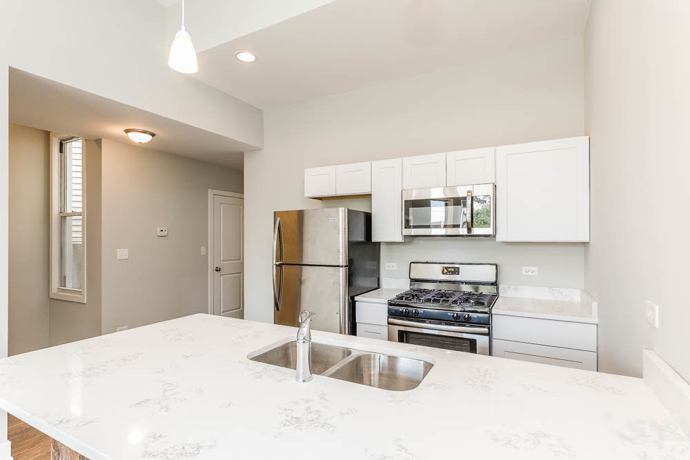 2228 West Cermak Road Chicago, IL 60608 - Photo 10 of 32 a kitchen with stainless steel appliances a refrigerator and a stove top oven