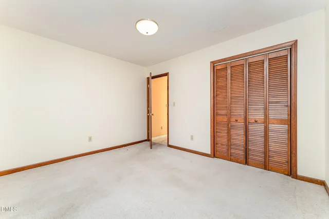 a bedroom with a bed and a potted plant