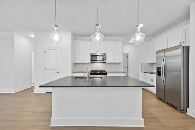a view of staircase with wooden floor and white walls