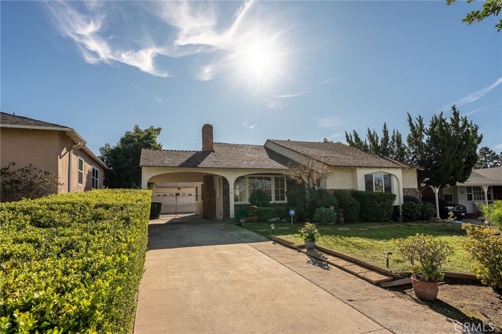 414 University Burbank, CA 91504 - Photo 17 of 18 a front view of a house with a garden and trees