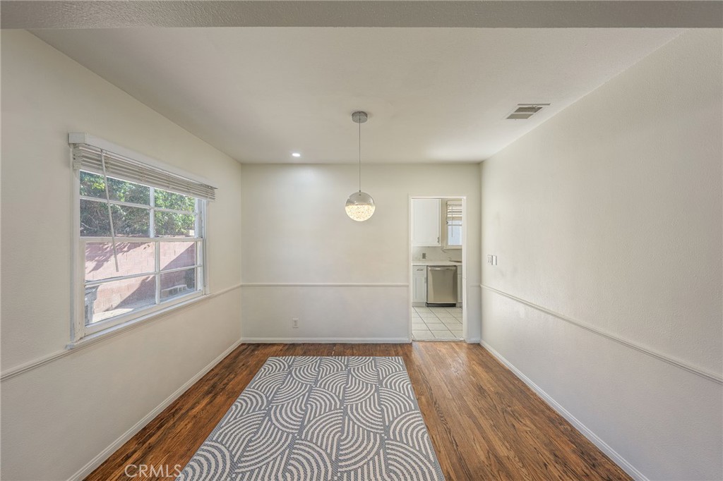 414 University Burbank, CA 91504 - Photo 4 of 18 an empty room with wooden floor and windows