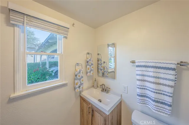 a bathroom with a sink toilet and mirror