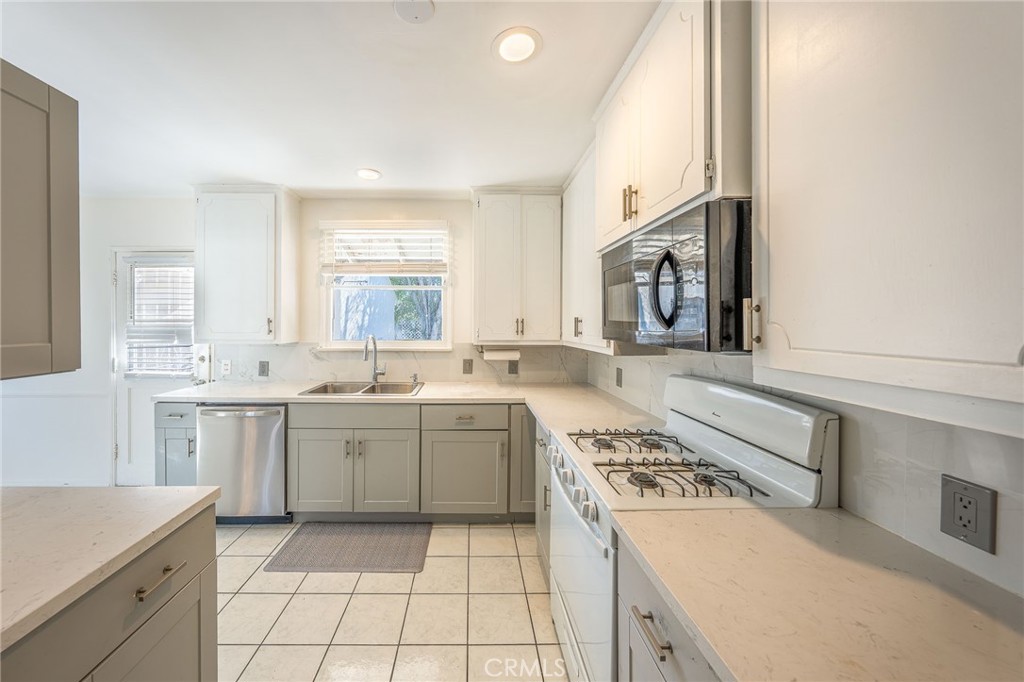 414 University Burbank, CA 91504 - Photo 8 of 18 a large kitchen with a stove and a sink