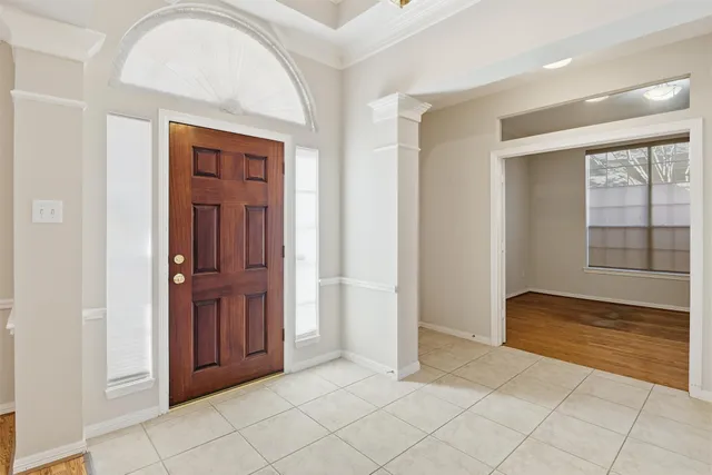 a view of a bedroom with wooden floor and bathroom