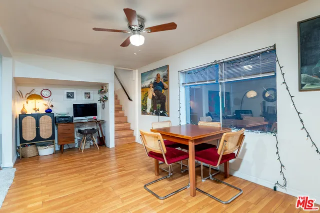 a dining room with furniture and wooden floor