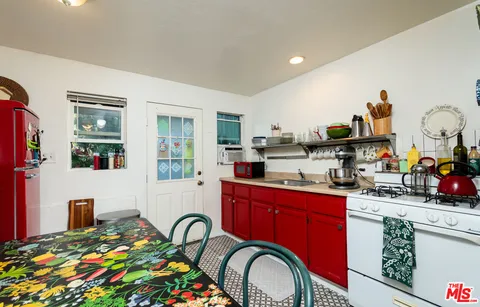 a bathroom with a sink a toilet and shower curtain