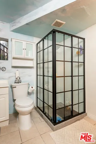 a balcony with furniture and a potted plant