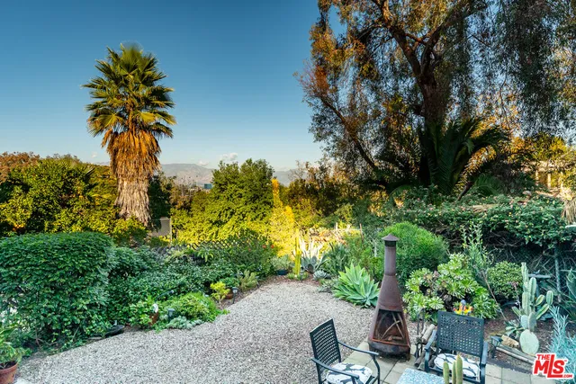 an aerial view of residential houses with outdoor space and swimming pool