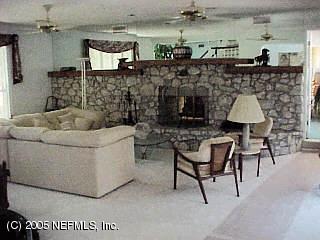 3590 Joe Ashton Road St. Augustine, FL 32092 - Photo 4 of 6 a living room with furniture and a fireplace