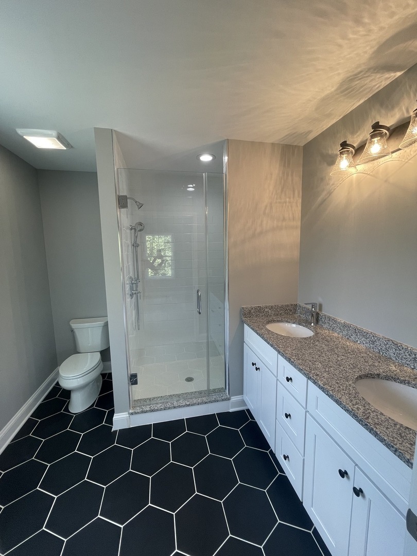 10934 Bryant Road Mokena, IL 60448 - Photo 16 of 24 a spacious bathroom with a granite countertop sink a toilet and a mirror