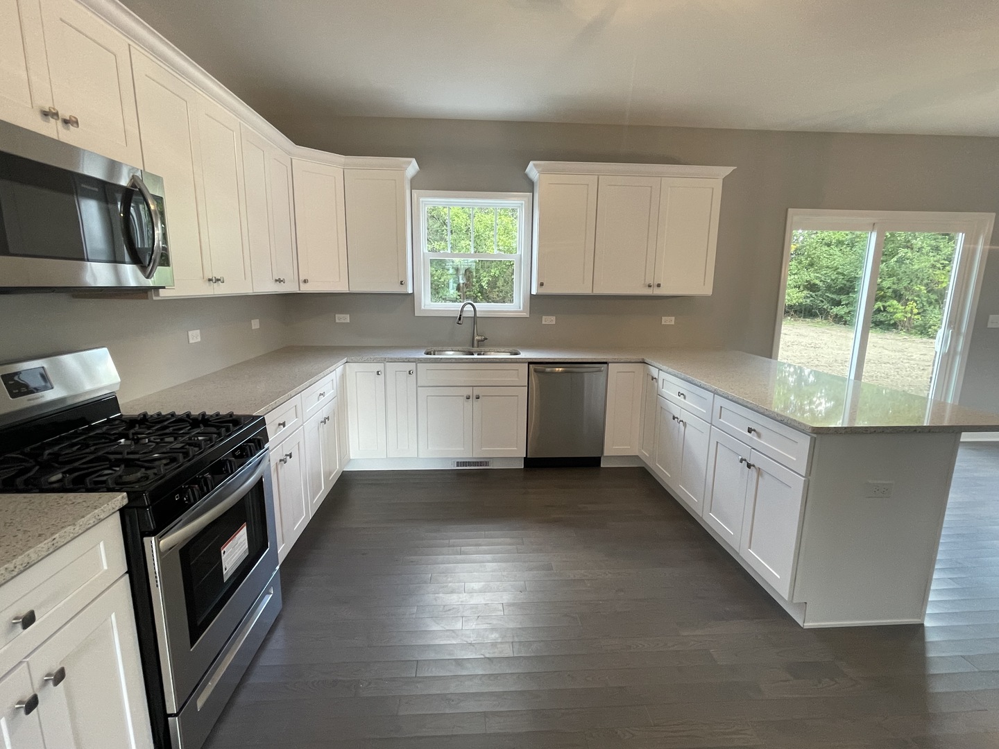 10934 Bryant Road Mokena, IL 60448 - Photo 5 of 24 a kitchen with granite countertop white cabinets and stainless steel appliances