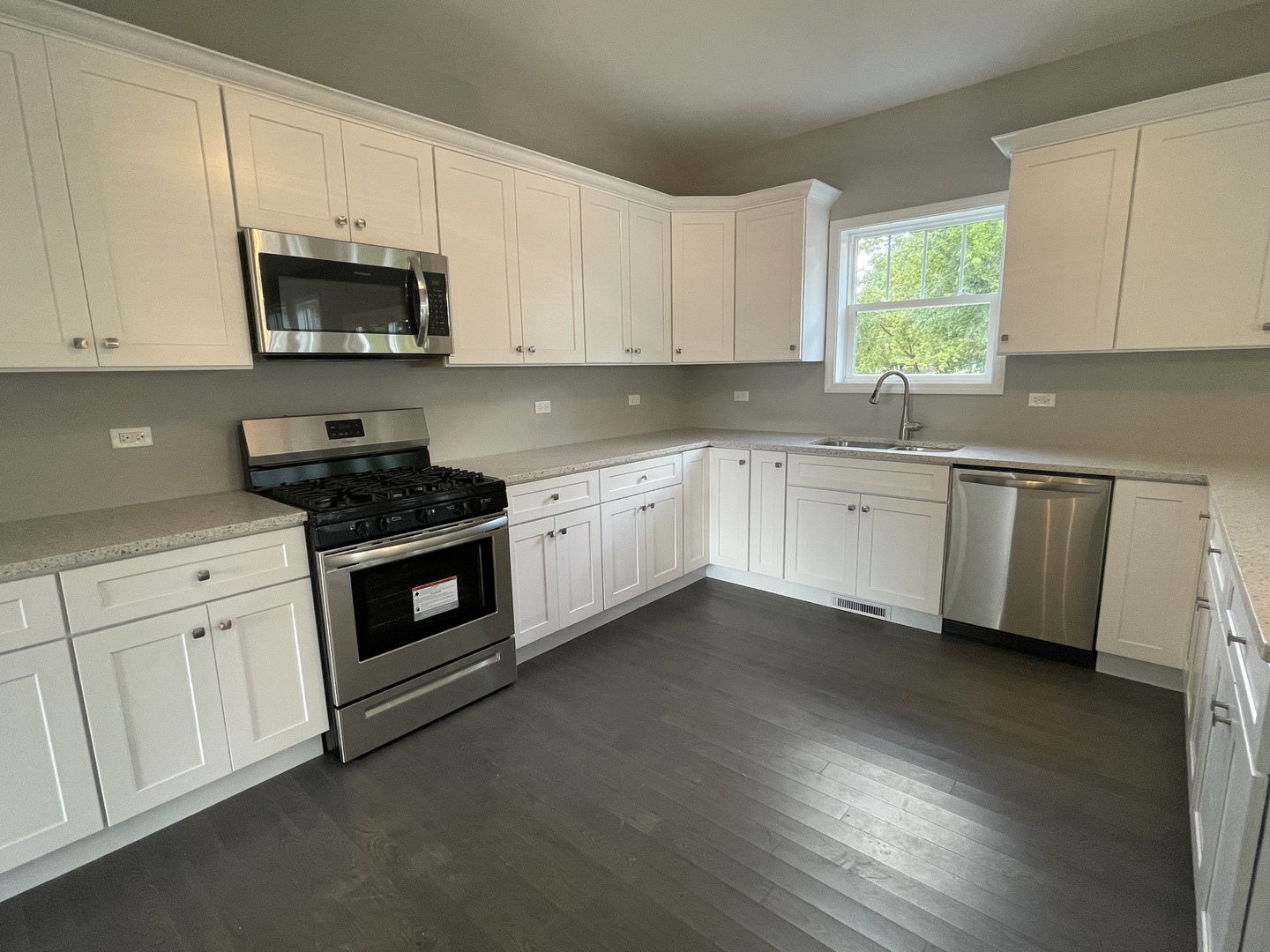 10934 Bryant Road Mokena, IL 60448 - Photo 6 of 24 a kitchen with granite countertop white cabinets and white appliances