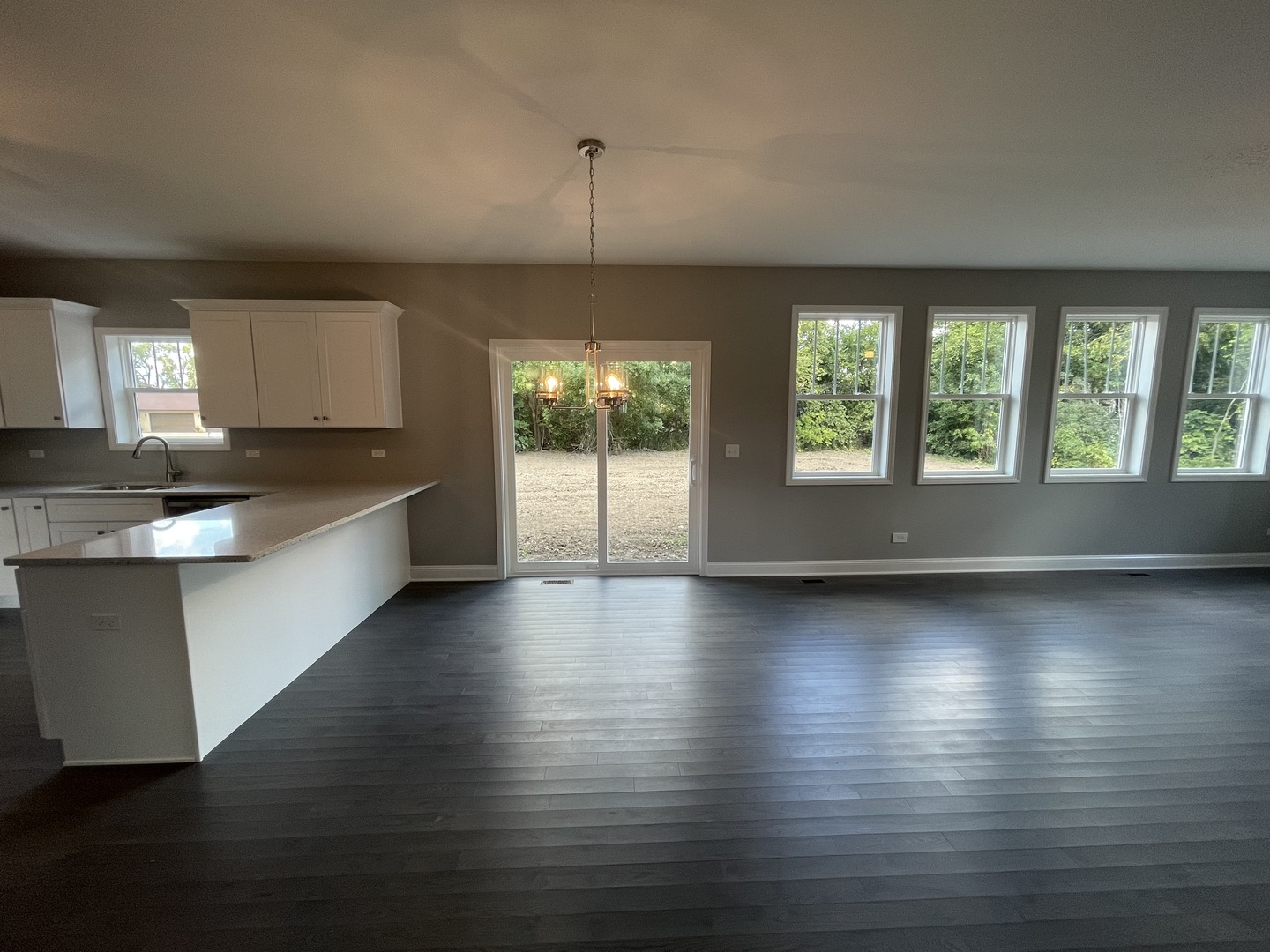10934 Bryant Road Mokena, IL 60448 - Photo 10 of 24 an open kitchen with granite countertop a stove and a wooden floors
