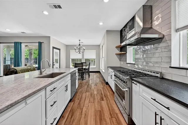 a kitchen with counter top space cabinets and stainless steel appliances