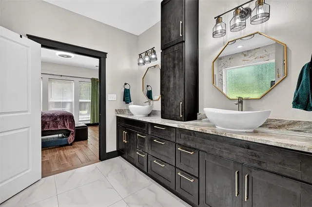 a bathroom with a tub sink shower and mirror