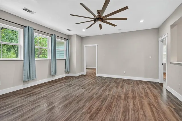 a bathroom with a granite countertop sink a mirror and a bathtub