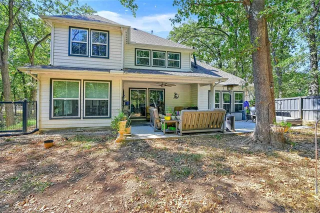 a front view of a house with garden and patio