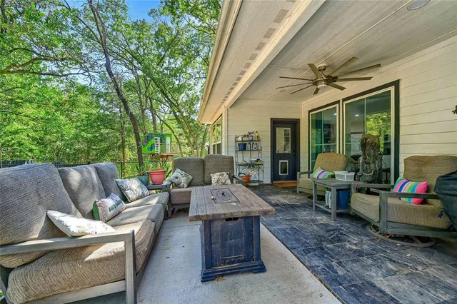 a view of a backyard with sitting area furniture and garden