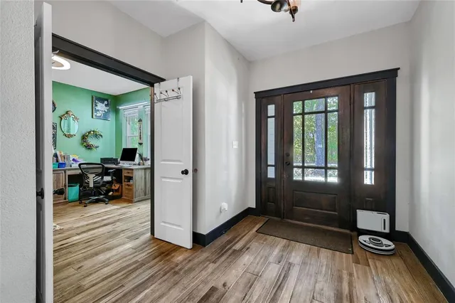 a living room with furniture a fireplace and a floor to ceiling window