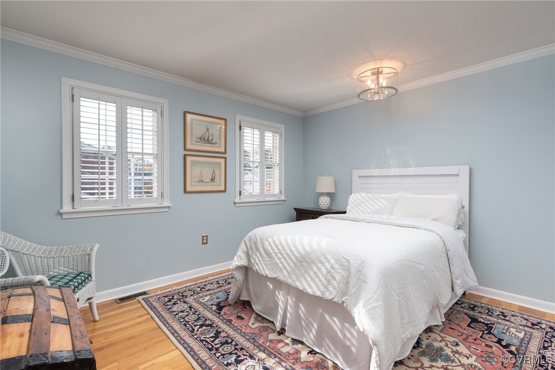 9111 Derbyshire Road, Unit I Henrico, VA 23229 - Photo 13 of 22 a bedroom with a bed and wooden floor