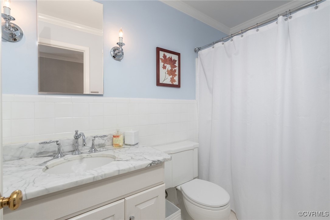 9111 Derbyshire Road, Unit I Henrico, VA 23229 - Photo 16 of 22 a bathroom with a granite countertop sink mirror vanity and toilet