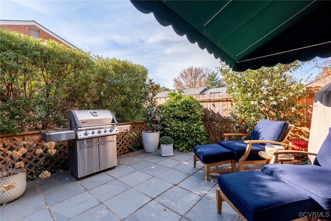 9111 Derbyshire Road, Unit I Henrico, VA 23229 - Photo 18 of 22 a view of a chairs and table in the back yard of the house