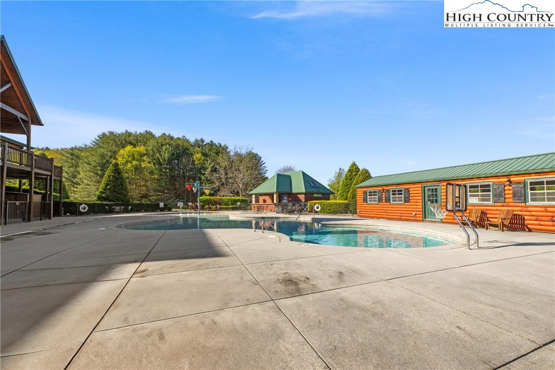 29 Pond View Lane Sparta, NC 28675 - Photo 17 of 27 a view of swimming pool with outdoor seating and house in the background