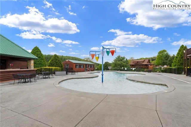 a swimming pool with outdoor seating
