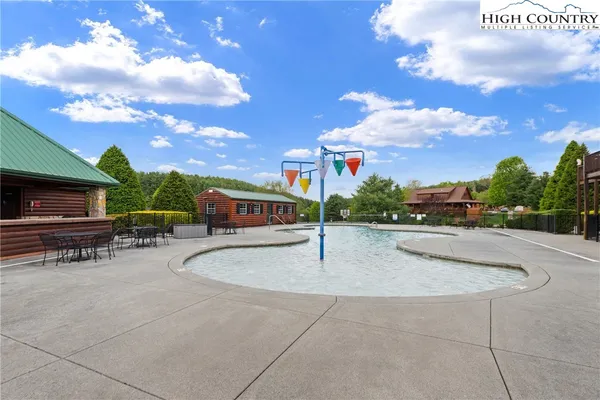 a swimming pool with outdoor seating