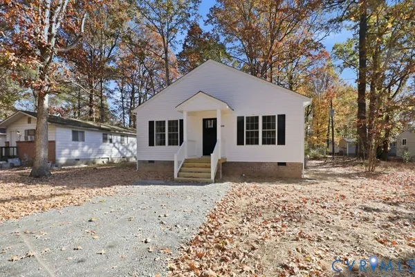 a front view of a house with a yard covered in snow
