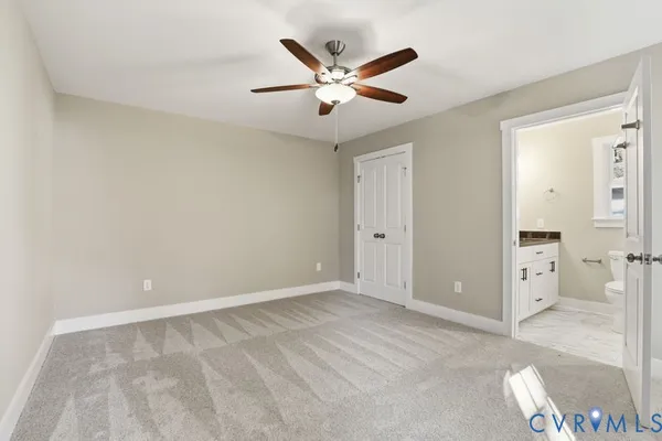 an empty room with closet and windows