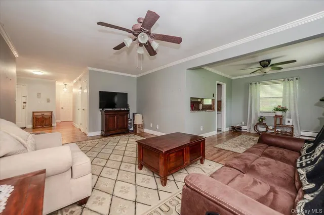 a view of a room with gym equipment and a chandelier