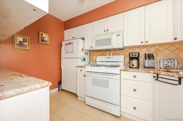 a kitchen with granite countertop a sink and a stove top oven