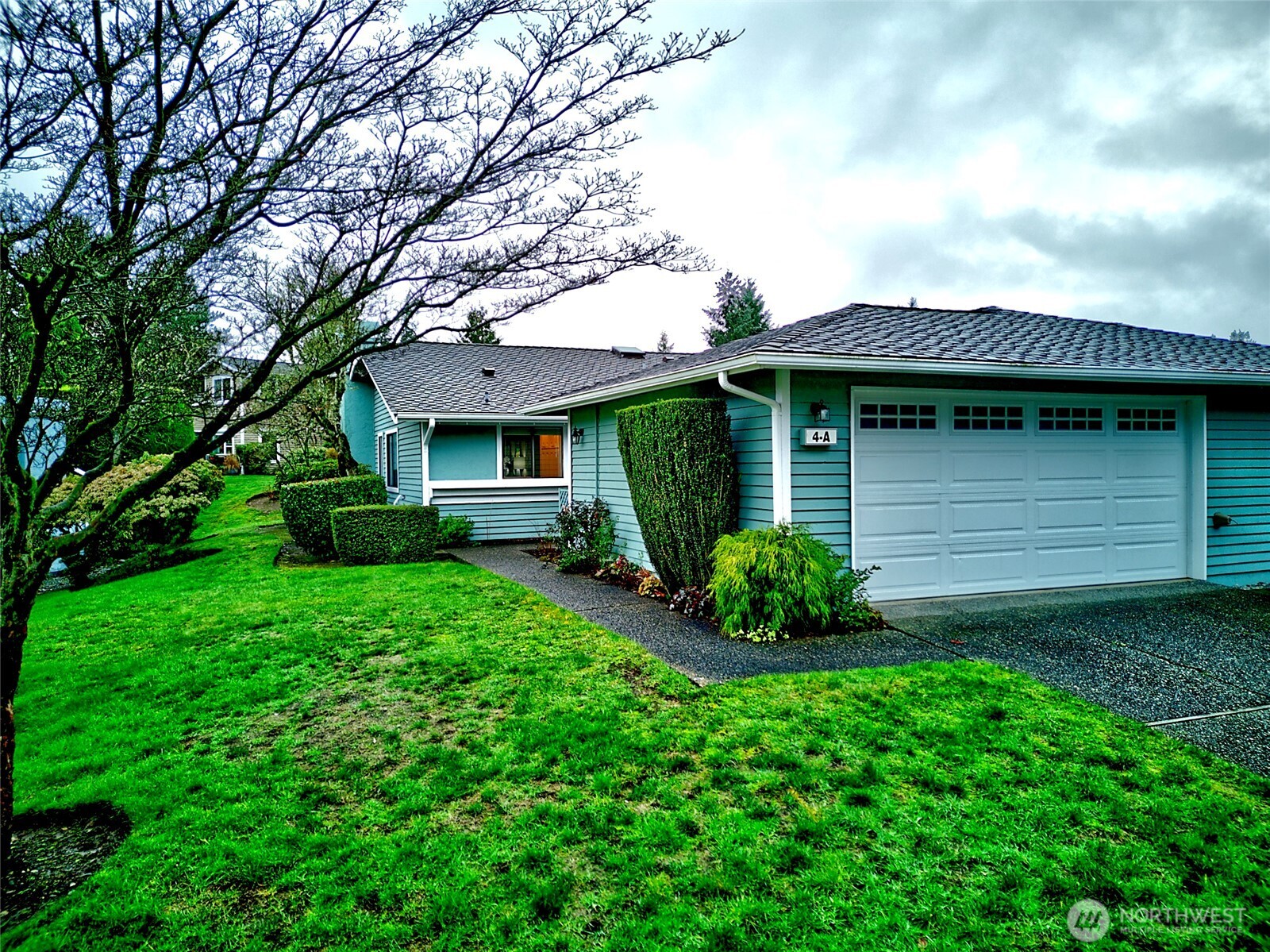 1800 Mill Creek Road, Unit 4A Mill Creek, WA 98012 - Photo 1 of 32 a view of a house with a garden