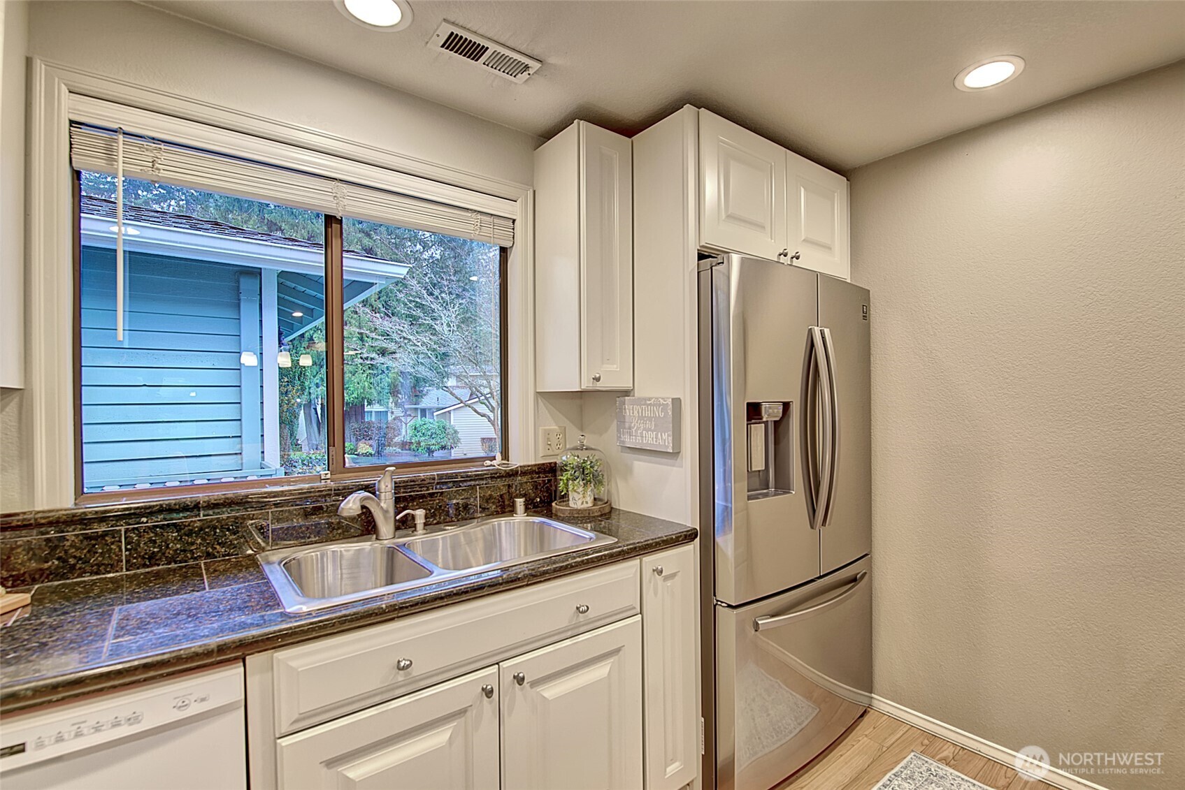 1800 Mill Creek Road, Unit 4A Mill Creek, WA 98012 - Photo 12 of 32 a kitchen with stainless steel appliances granite countertop a refrigerator and a sink