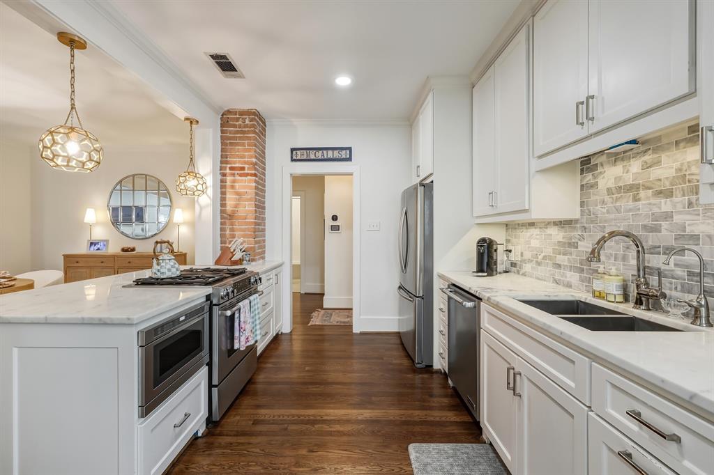 5250 Goodwin Avenue Dallas, TX 75206 - Photo 13 of 33 a kitchen with stainless steel appliances granite countertop a stove and a sink