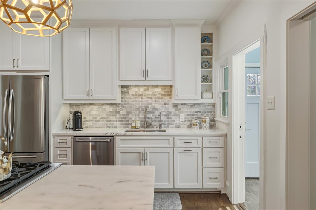 5250 Goodwin Avenue Dallas, TX 75206 - Photo 14 of 33 a kitchen with stainless steel appliances a sink stove and refrigerator