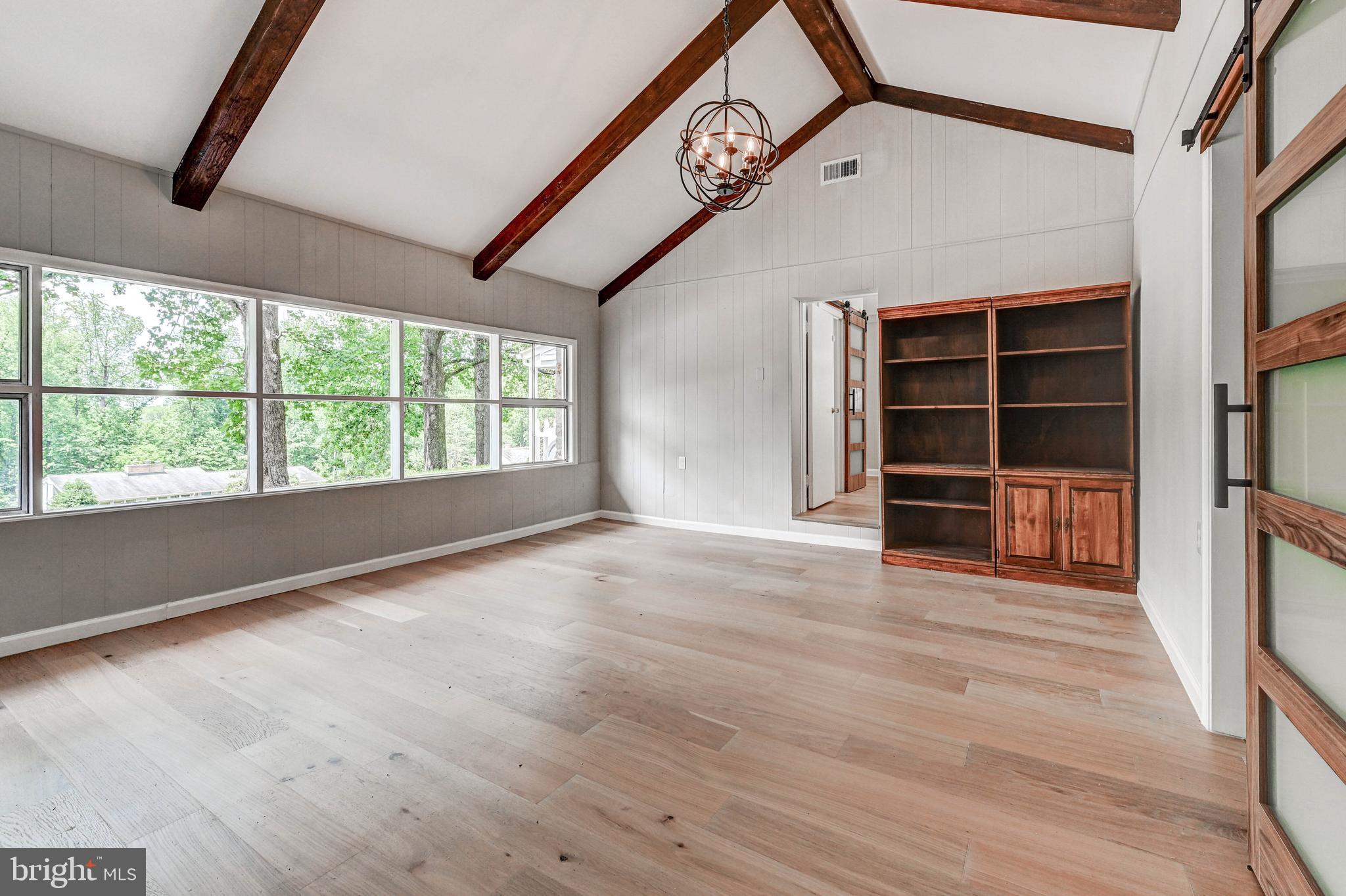 1311 Milldam Road Baltimore, MD 21286 - Photo 13 of 27 wooden floor in an empty room with a window