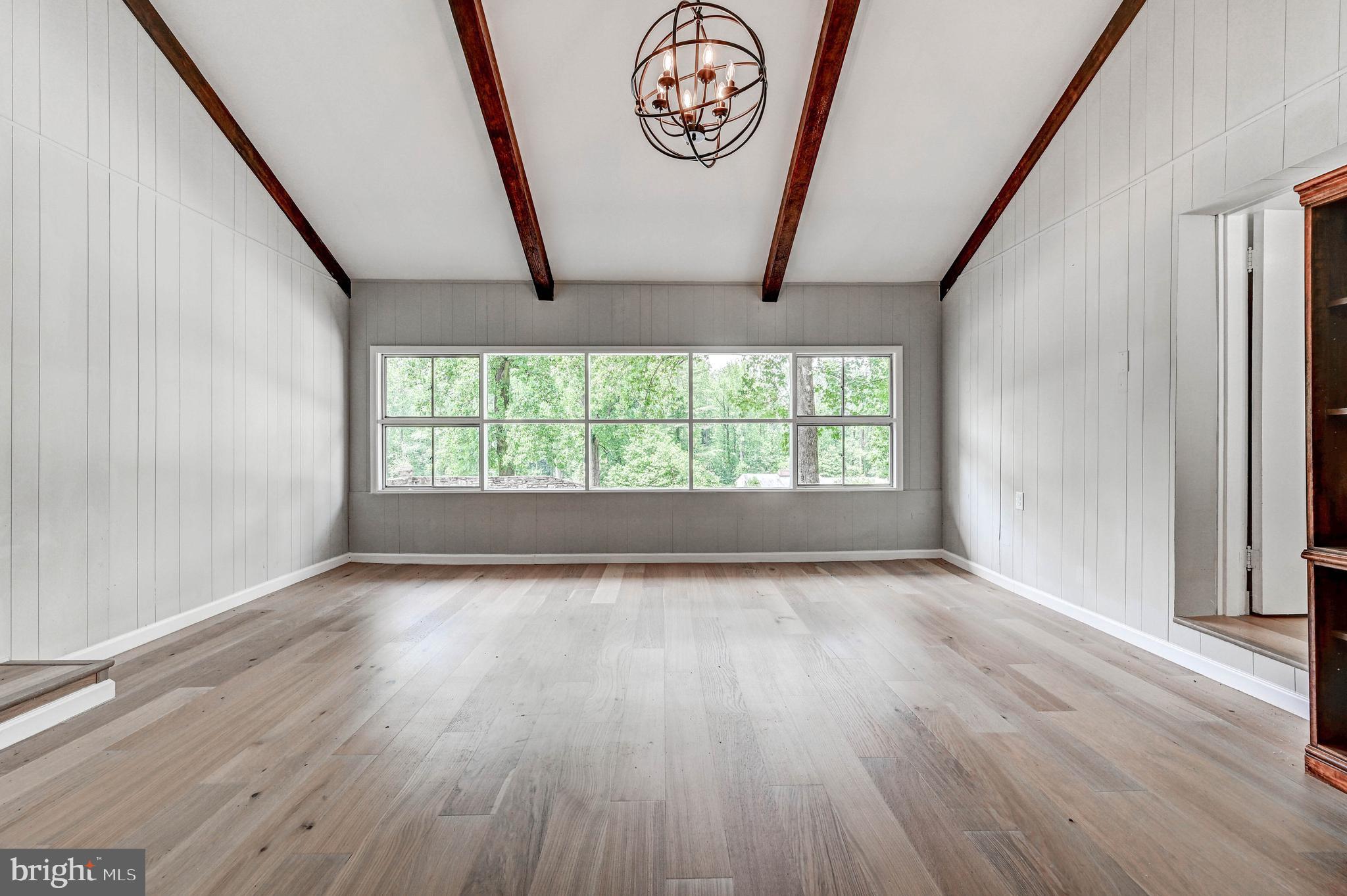 1311 Milldam Road Baltimore, MD 21286 - Photo 16 of 27 an empty room with wooden floor and window