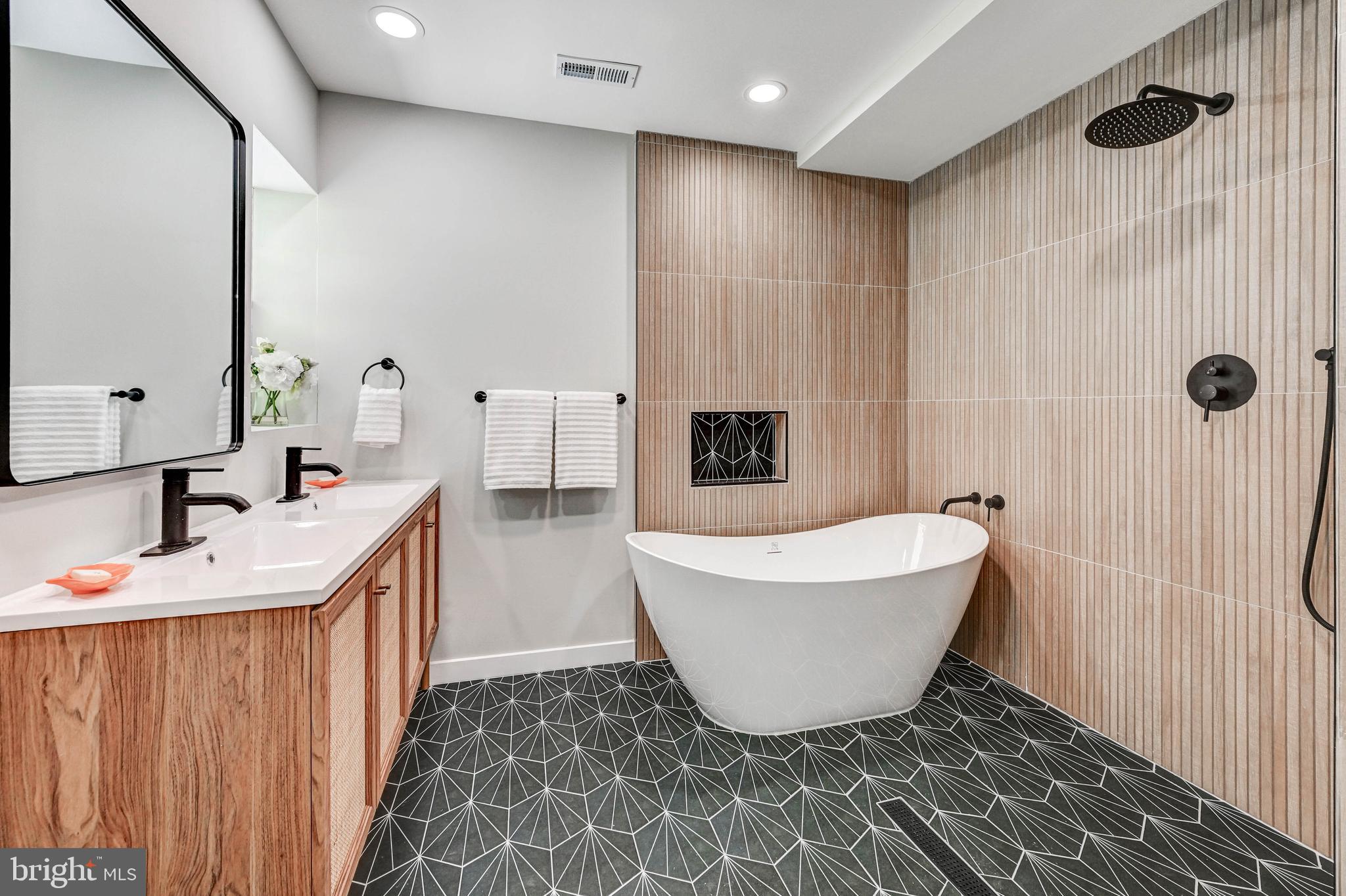 1311 Milldam Road Baltimore, MD 21286 - Photo 19 of 27 a bathroom with a bathtub sink and mirror