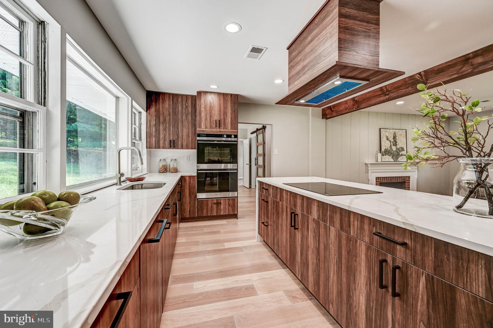1311 Milldam Road Baltimore, MD 21286 - Photo 24 of 27 a kitchen with kitchen island granite countertop a sink appliances cabinets and a counter top space