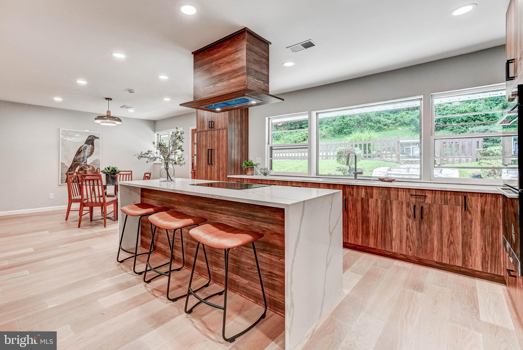 1311 Milldam Road Baltimore, MD 21286 - Photo 9 of 27 a dining hall with stainless steel appliances granite countertop a table chairs and a large window