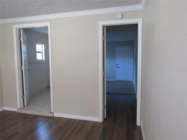 a view of a hallway with wooden floor