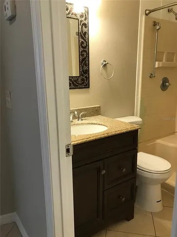 a view of a small space with wooden floor and a window