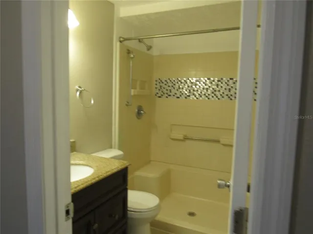 a bathroom with a granite countertop sink