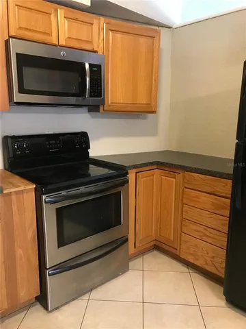 a kitchen with a stove and microwave