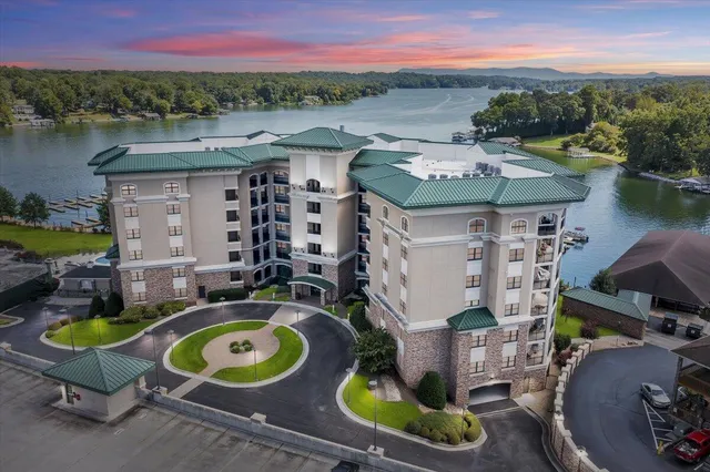 an aerial view of a house with outdoor space and lake view