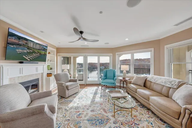a living room with furniture large window and a fireplace