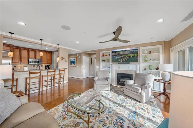 a living room with furniture wooden floor and a fireplace